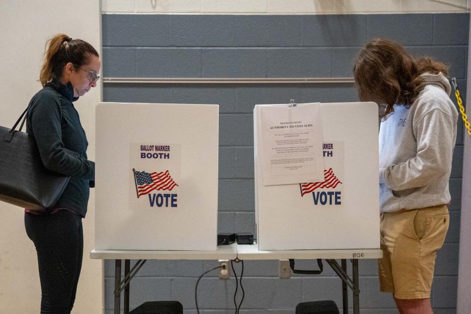 Lisa Keller, of Upper Arlington, and Sammy Sallerson, of Upper Arlington, cast their votes at Burbank Early Childhood School on Tuesday,