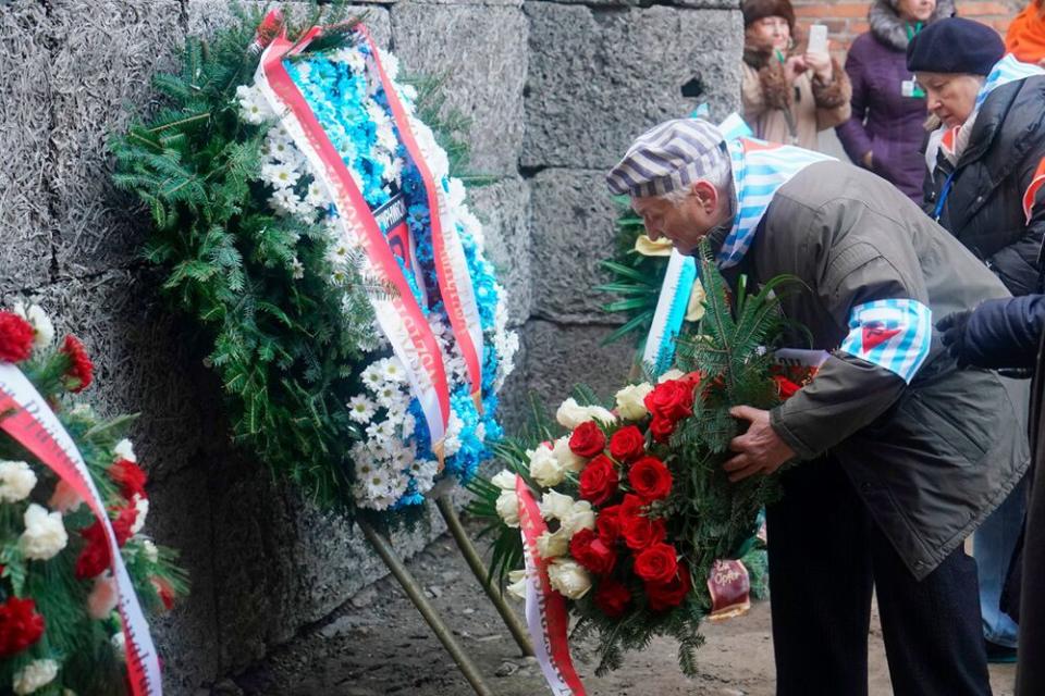 Survivors laying wreaths | JANEK SKARZYNSKI/AFP via Getty