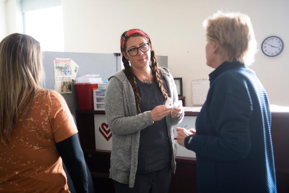 Teighla McKinney chats with coworkers in November at the Free Medical Clinic of Oak Ridge.