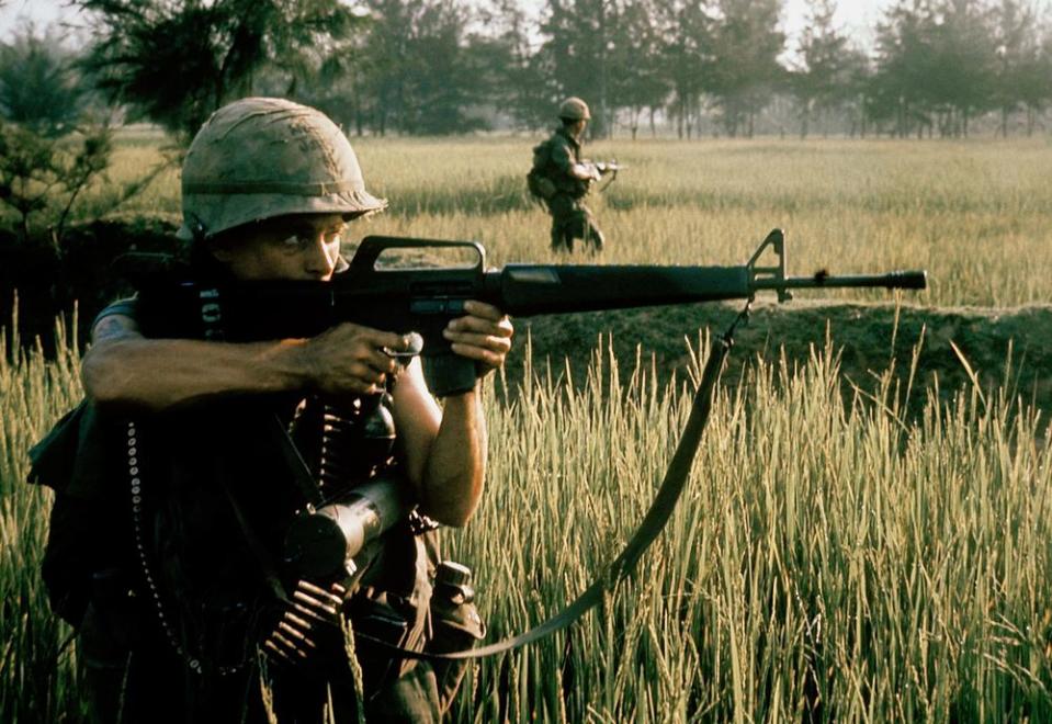 An American soldier fires his M16 rifle near My Lai on March 16, 1968.