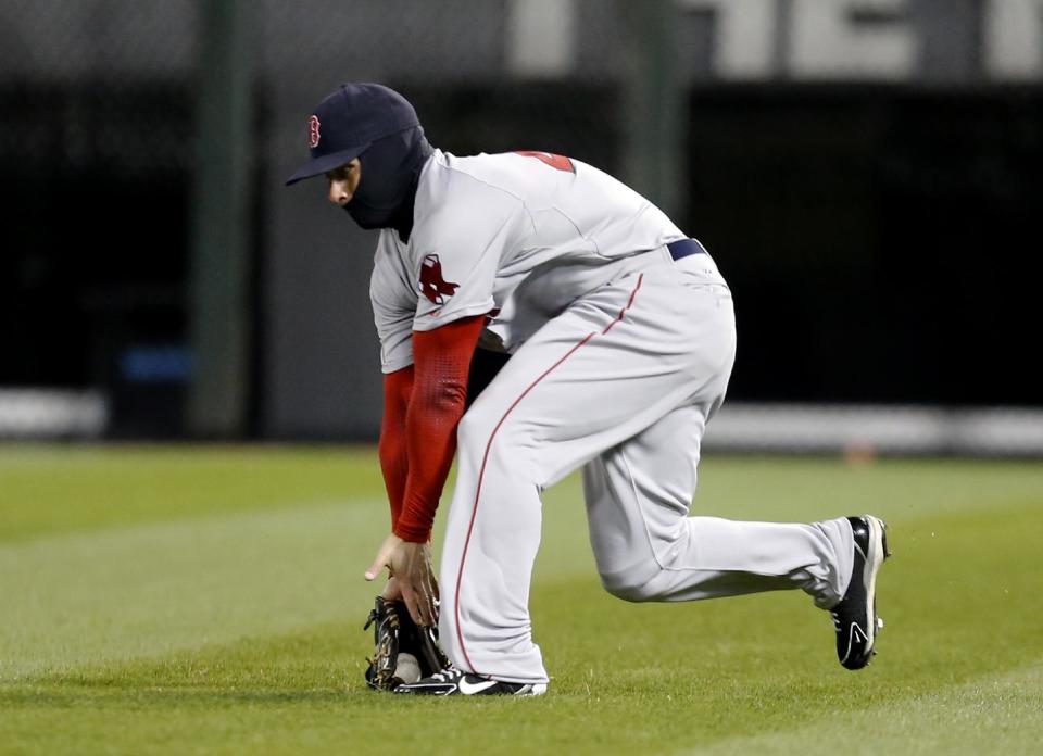 Boston Red Sox right fielder Daniel Nava makes a shoestring catch on a fly ball hit by Chicago White Sox's Marcus Semien during the seventh inning of a baseball game Tuesday, April 15, 2014, in Chicago. (AP Photo/Charles Rex Arbogast)