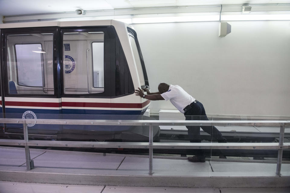 <p>A worker pushes a senate subway car Friday morning as the Senate considers the House passed continuing resolution to fund the government on Jan. 19, 2018. (Photo: Tom Williams/Congressional Quarterly/Newscom via ZUMA Press) </p>