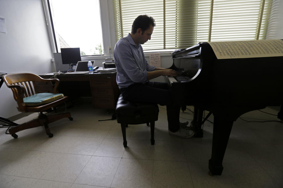 Yotam Haber plays the piano while working on the finishing touches of his composition "A More Convenient Season" in his office at the University of New Orleans on Thursday, Sept. 5, 2013. Rather than focus in a literal way on the Sept. 15, 1963, Ku Klux Klan bombing that killed four little black girls on their way to Sunday school, the Dutch-born composer sought to evoke Birmingham's role in the larger civil rights struggle. "I'm not telling Birmingham her own story," says Haber, whose work is scheduled to premiere at the University of Alabama on Sept. 21, 2013. "She knows it far better than I will ever be able to tell it." (AP Photo/Gerald Herbert)