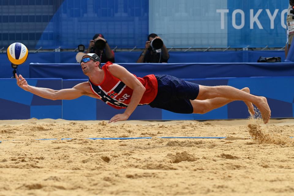 <p>Norway's Anders Berntsen Mol reaches for the ball in their men's beach volleyball quarter-final match between Russia and Norway during the Tokyo 2020 Olympic Games at Shiokaze Park in Tokyo on August 4, 2021. (Photo by Martin BERNETTI / AFP)</p> 