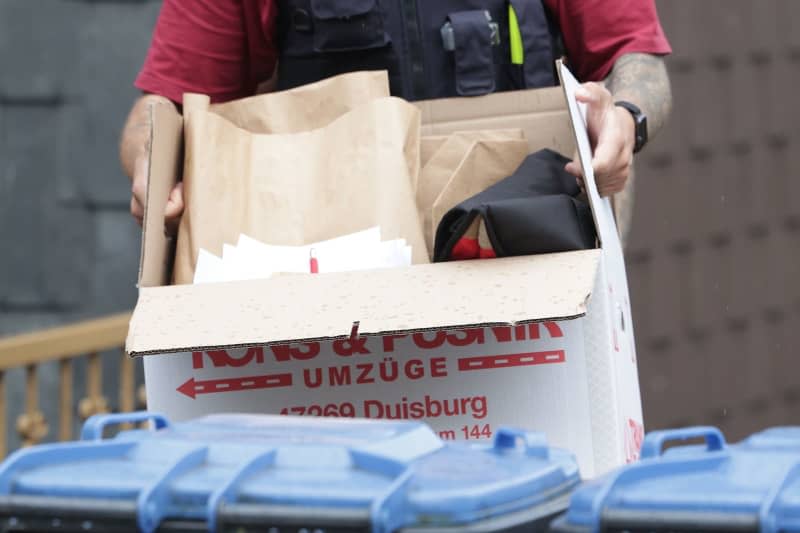 A German police officer carries a box of seized items following a search of an apartment, as part of action taken against a group allegedly supporting Hamas. The raid comes as the Ministry of the Interior in North Rhine-Westphalia on 16 May also banned the Palestine Solidarity Duisburg. David Young/dpa