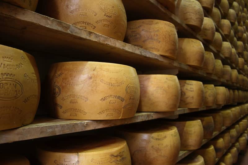 Several wheels of Gran Moravia cheese lie in a Brazzale warehouse. Dairy entrepreneur Roberto Brazzale only employs people over 60 for a special branch of his dairy business. Brazzale AG/dpa