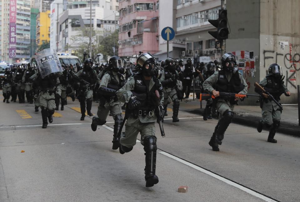 Police arrive to chase away protestors in Hong Kong, Sunday, Oct. 20, 2019. Hong Kong protesters again flooded streets on Sunday, ignoring a police ban on the rally and setting up barricades amid tear gas and firebombs. (AP Photo/Kin Cheung)