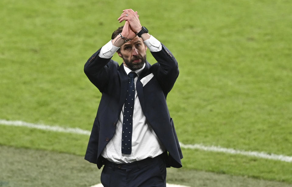 England's manager Gareth Southgate gestures to the crowd as England celebrate after defeating Denmark in their Euro 2020 soccer championship semifinal at Wembley stadium in London, Wednesday, July 7, 2021. (Justin Tallis/Pool Photo via AP)