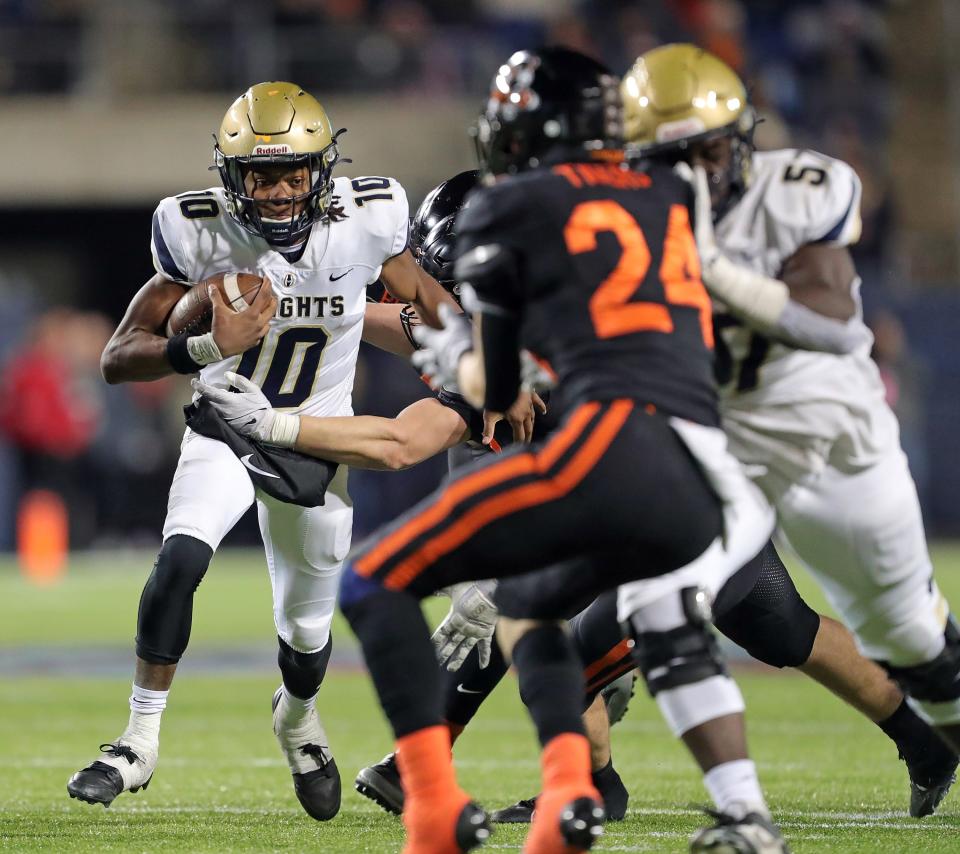 Hoban quarterback Tylan Boykin, left, rushes for a short gain during the second half.