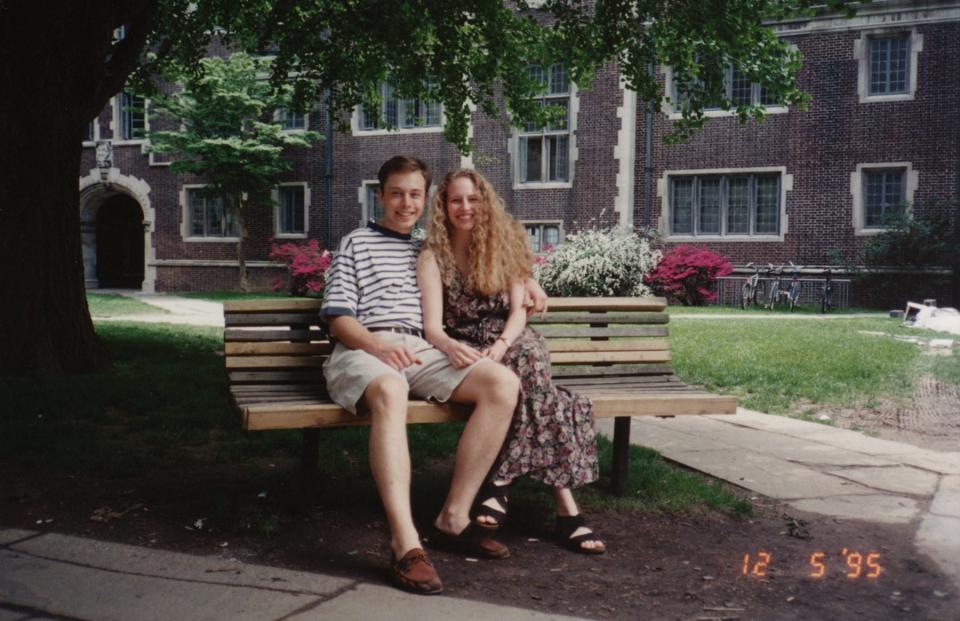 Elon Musk seated on a bench with his then-girlfriend Jennifer Gwynne.