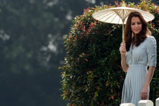 Catherine, Duchess of Cambridge, looks at the headstones during her visit to the Kranji Memorial Cemetery in Singapore on September 13. In Singapore, William caused a stir when he revealed that he wanted to have two children with Catherine, according to British media accompanying them