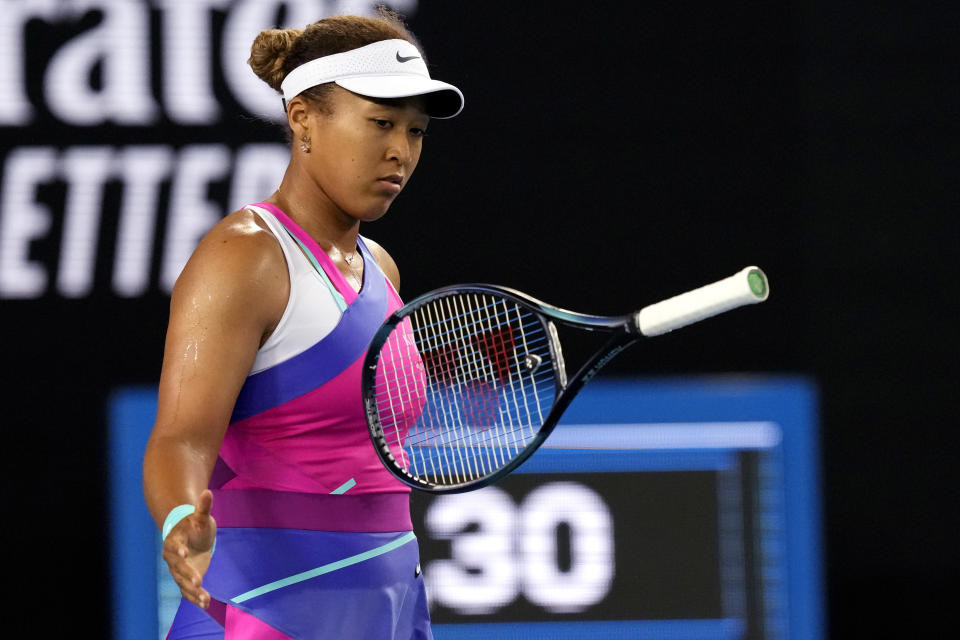 Naomi Osaka of Japan bounces her racket in frustration during her third Rond match against Amanda Anisimova of the U.S. at the Australian Open tennis championships in Melbourne, Australia, Friday, Jan. 21, 2022. (AP Photo/Simon Baker)