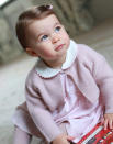 <p>Charlotte shows off her baby blues in a photo taken by mom in a pink cardigan and printed dress.</p>