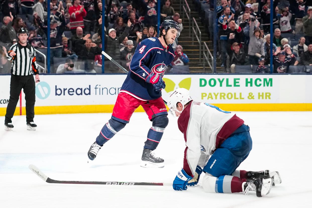 Apr 1, 2024; Columbus, Ohio, USA; Columbus Blue Jackets center Cole Sillinger (4) celebrates an empty net goal behind Colorado Avalanche defenseman Cale Makar (8) during the third period of the NHL hockey game at Nationwide Arena. The Blue Jackets won 4-1.