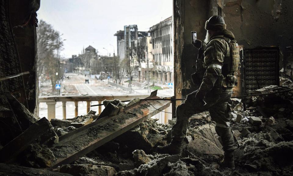 A Russian soldier patrols a Mariupol theater in Ukraine, bombed by Russian troops in March 2022. <a href="https://media.gettyimages.com/id/1239934838/photo/topshot-ukraine-russia-conflict.jpg?s=1024x1024&w=gi&k=20&c=yatY8oL5OJwFUDdYl4UZMys0tsKFCkXkZJS-jHYJFUk=" rel="nofollow noopener" target="_blank" data-ylk="slk:Alexander Nemenov/AFP via Getty Images;elm:context_link;itc:0;sec:content-canvas" class="link ">Alexander Nemenov/AFP via Getty Images</a>