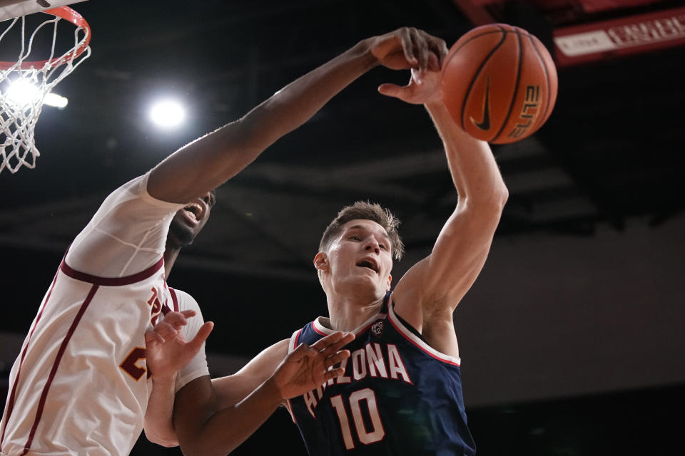 Southern California forward Joshua Morgan, left, and Arizona forward Azuolas Tubelis reach for a rebound during the second half of an NCAA college basketball game Thursday, March 2, 2023, in Los Angeles. (AP Photo/Mark J. Terrill)