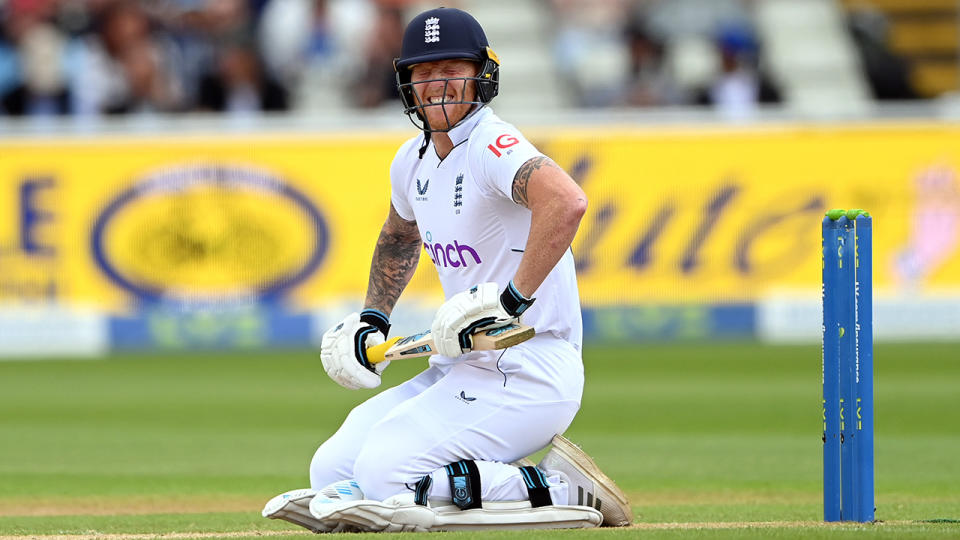 Ben Stokes grimaces in pain after being struck by a delivery against India.