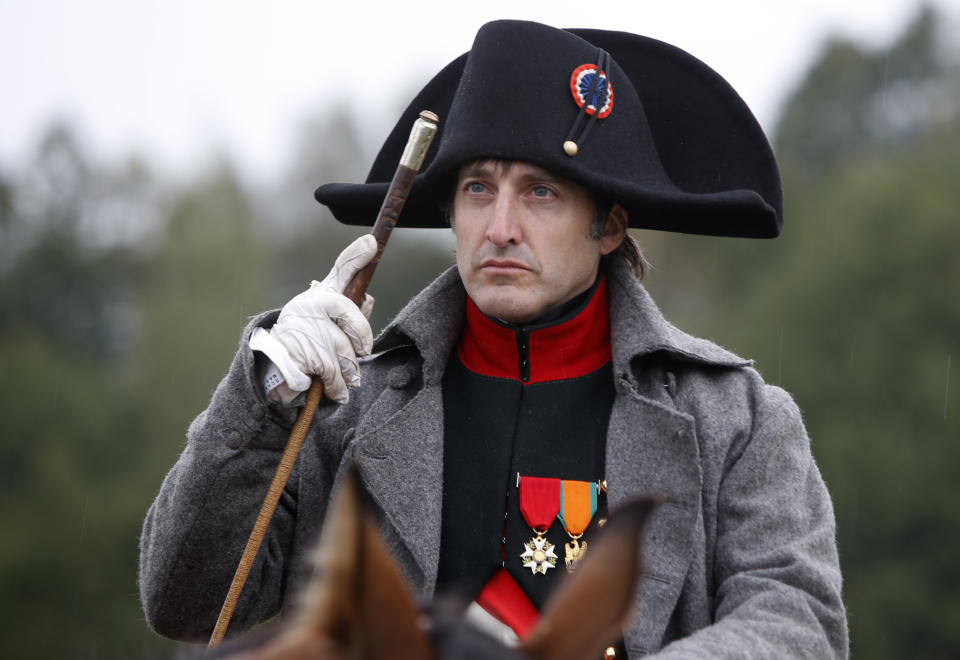 An actor playing the part of French Emperor Napoleon Bonaparte, center, as other members of historic clubs wearing 1812-era uniforms perform during a staged battle re-enactment to mark the 200th anniversary of the battle of Borodino, in Borodino, about 110 km (70 miles) west of Moscow, Sunday, Sept. 2, 2012. Russia marks on Sunday the 200th anniversary of the Battle of Borodino which in 1812 was the largest and bloodiest single-day action of the French invasion of Russia. (AP Photo/Alexander Zemlianichenko)