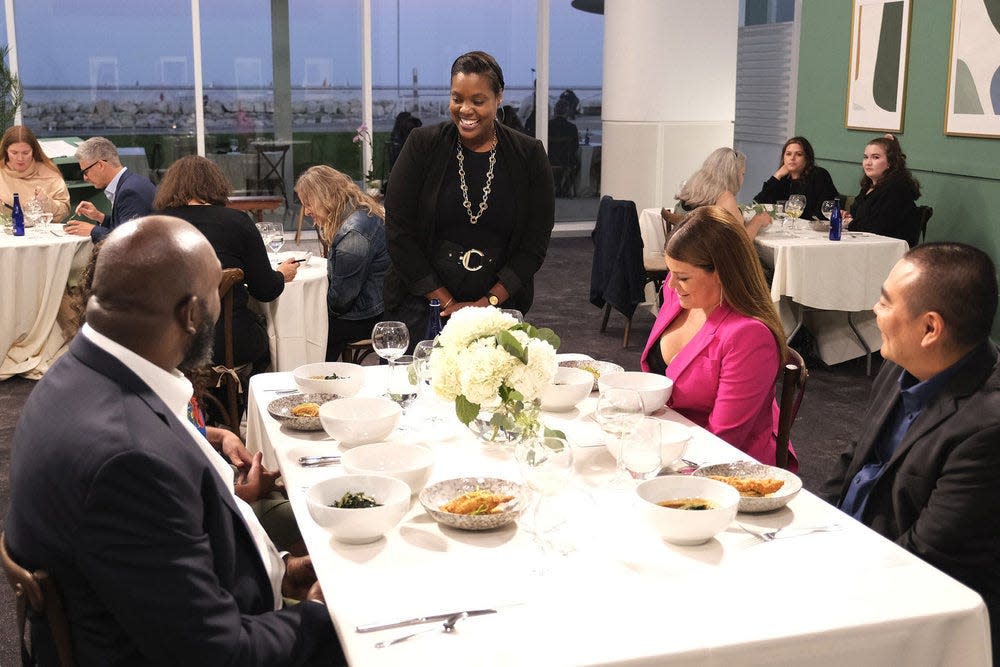"Top Chef: Wisconsin" contestant Michelle Wallace (center), welcomes guest judge Erick Williams (clockwise from bottom left), judge Gail Simmons and guest judge Itaru Nagano to her team's pop-up seafood restaurant, Channel, at Milwaukee's Discovery World during the Restaurant Wars episode.