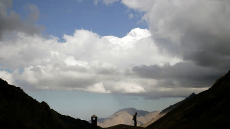 FILE PHOTO: A mountaineer looks for Toubkal valley at the Atlas region near Imlil October 30, 2009. REUTERS/Rafael Marchante/File Photo