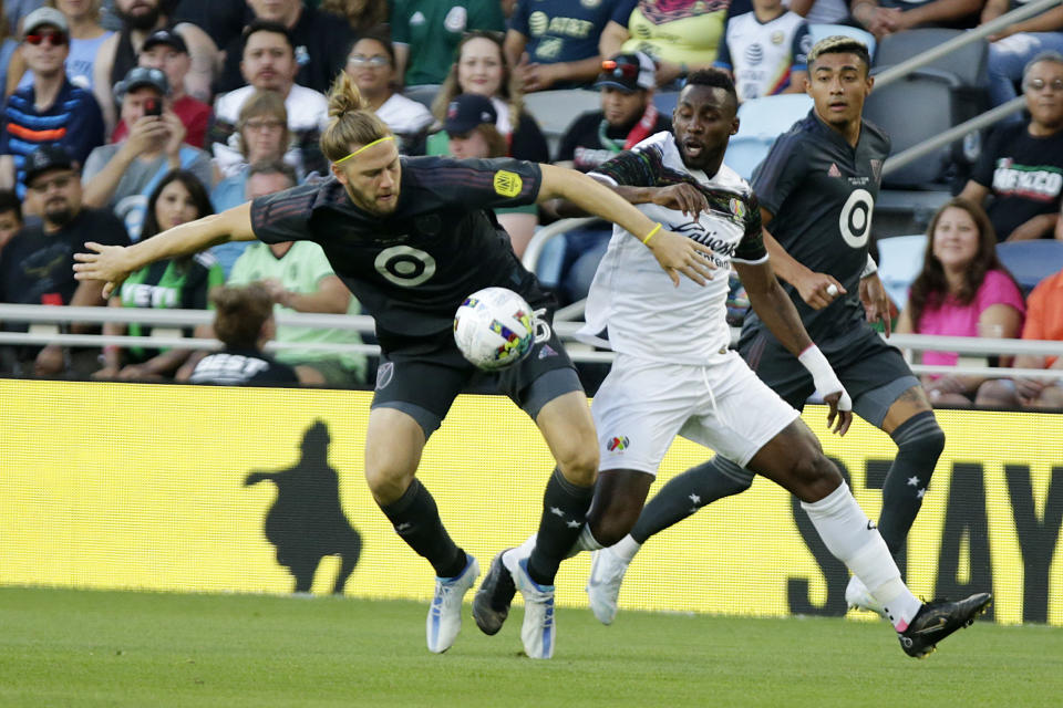MLS All-Star Walker Zimmerman, left, and Liga MX All-Star Julián Quiñones vie for the ball during the first half of the MLS All-Star soccer match Wednesday, Aug. 10, 2022, in St. Paul, Minn. (AP Photo/Andy Clayton-King)