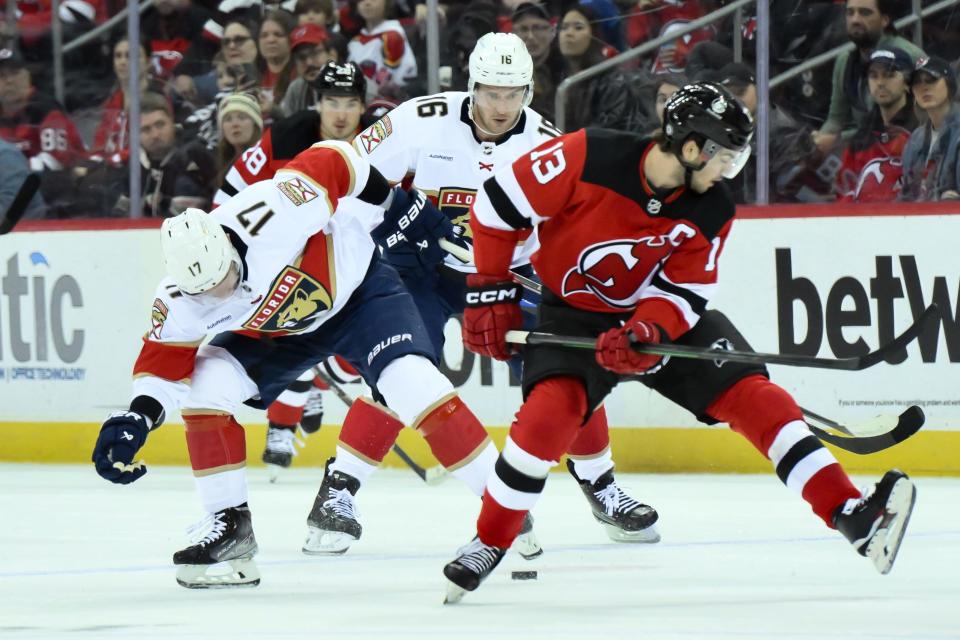 Oct 16, 2023; Newark, New Jersey, USA; Florida Panthers center Evan Rodrigues (17) tries to gain control of the puck against the New Jersey Devils during the first period at Prudential Center. Mandatory Credit: John Jones-USA TODAY Sports