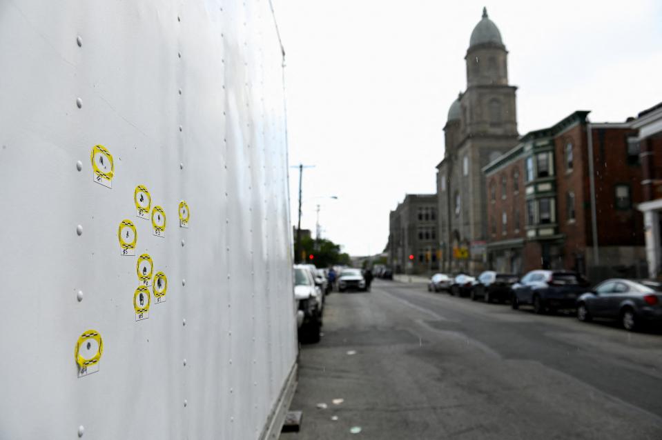 Bullet holes found on the side of a parked truck are marked as police officers work at the scene the day after a shooting in the Kingsessing section of southwest Philadelphia (Bastiaan Slabbers/Reuters)