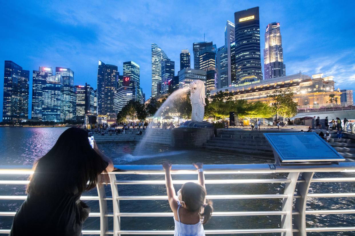 Tourists visit Singapore's Merlion statue at the Merlion Park.