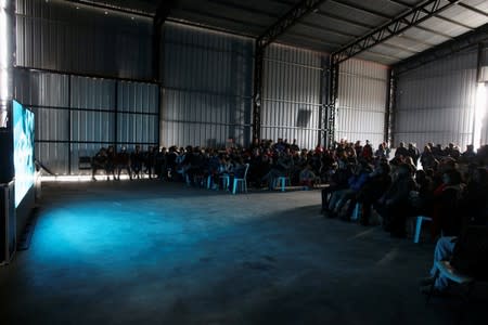 Workers of the "Bella Flor" cooperative watch the documentary "Nueva Mente" at the state entity CEAMSE that deals with waste management for the city and province of Buenos Aires, in the neighborhood of Jose Leon Suarez