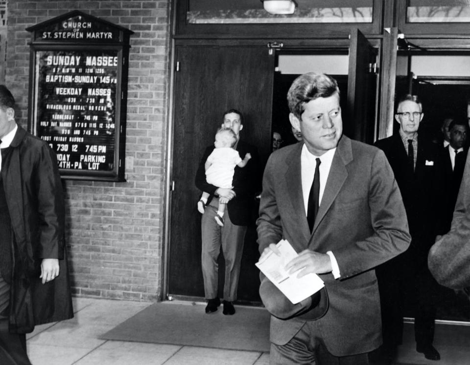 US President John Fitzgerald Kennedy leaves the Saint Stephen Martyr catholic church after attending mass, on October 28, 1962 in Washington DC.