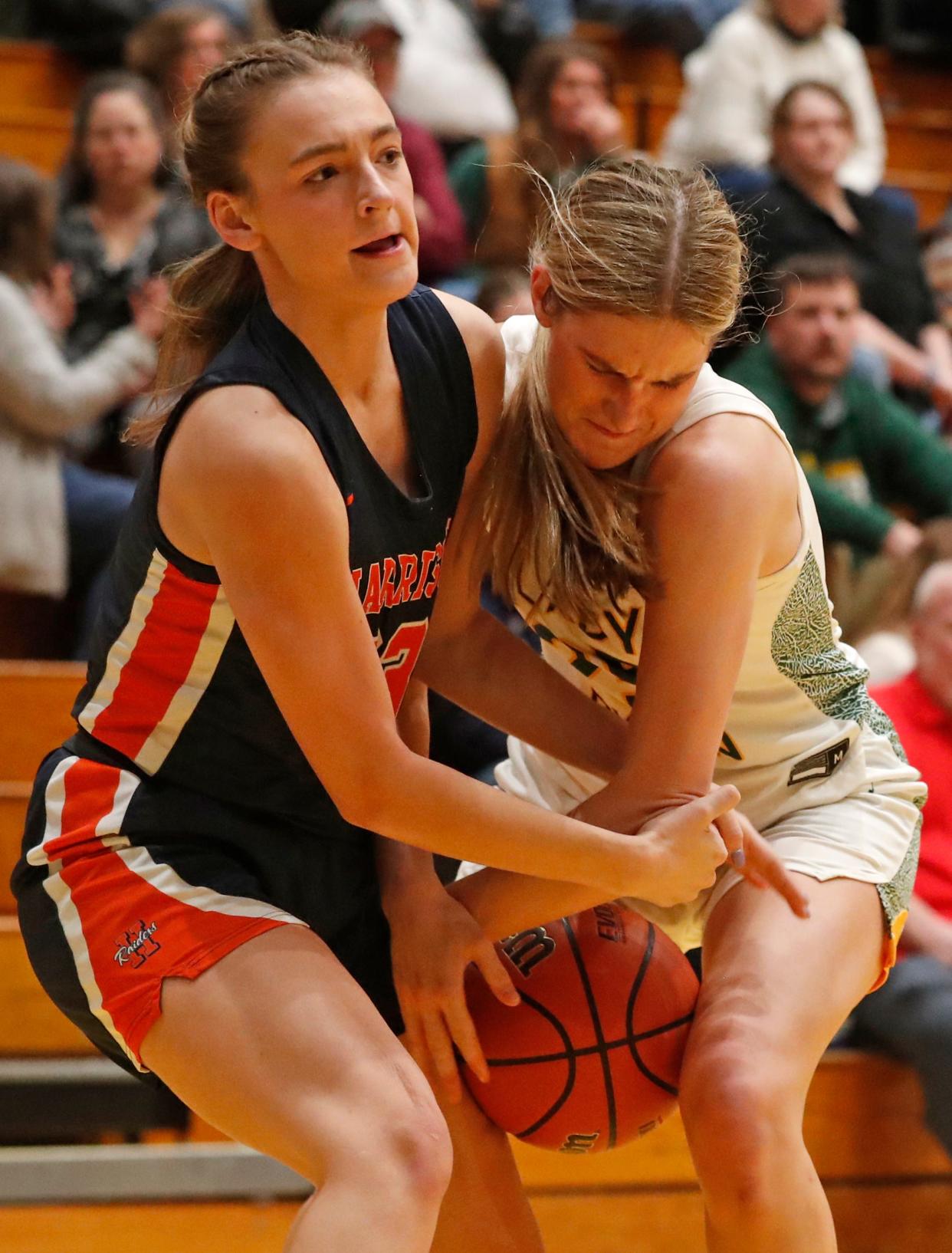 Harrison Raiders Kiersten Guyer (33) and Benton Central Bison center Sarah Gick (25) fight for possession during the IHSAA girl’s basketball game, Friday, Jan. 26, 2024, at Benton Central High School in Oxford, Ind. Benton Central won 59-31.