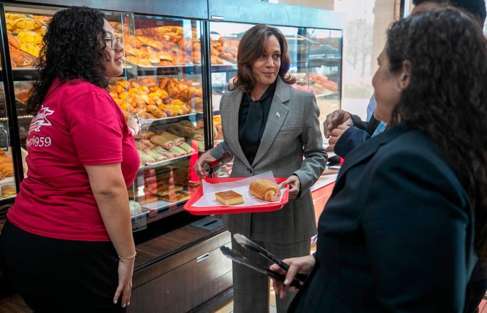 Astrid Sabillon, left, helps Vice President Kamala Harris during her visit to Panaderia Artisanal, a Latina-owned bakery on Monday, January 30, 2023 in Raleigh, N.C.