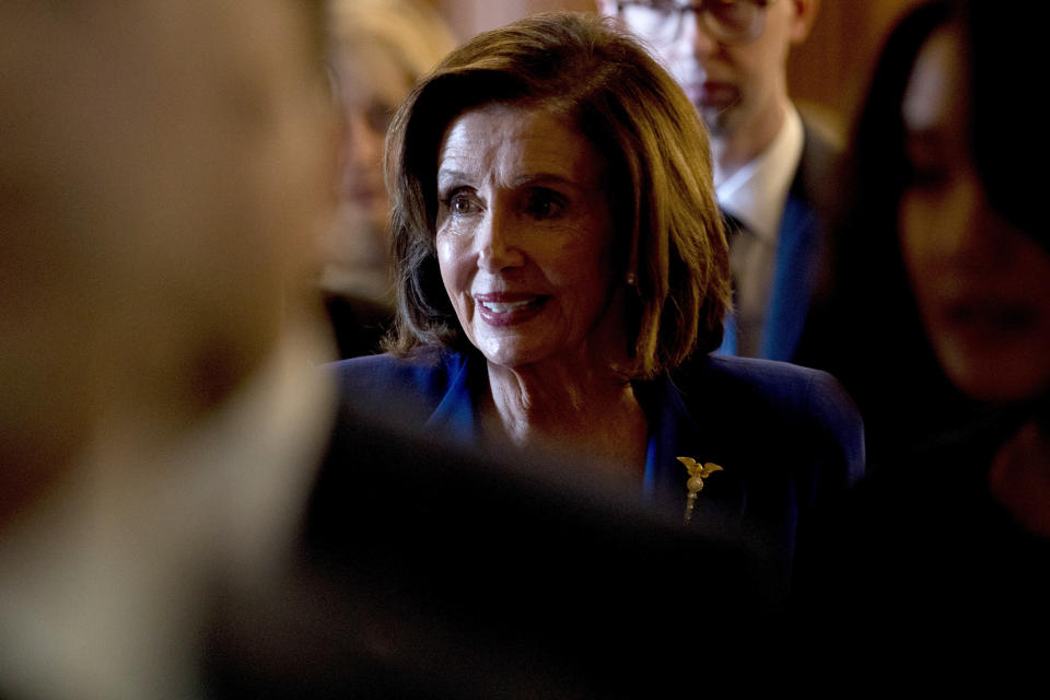 House Speaker Nancy Pelosi of Calif., walks to her office after signing the Coronavirus Aid, Relief, and Economic Security (CARES) Act after it passed in the House on Capitol Hill, Friday, March 27, 2020, in Washington. The $2.2 trillion package will head to head to President Donald Trump for his signature. (AP Photo/Andrew Harnik)