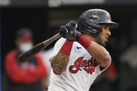 Cleveland Indians' Eddie Rosario watches his infield grounder that drove in a run during the first inning of the team's baseball game against the Detroit Tigers, Friday, April 9, 2021, in Cleveland. (AP Photo/Tony Dejak)