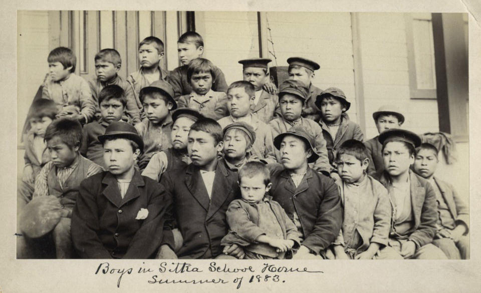 This photo made available by the Presbyterian Historical Society, Philadelphia shows students at a Presbyterian boarding school in Sitka, Alaska in the summer of 1883. U.S. Catholic and Protestant denominations operated more than 150 boarding schools between the 19th and 20th centuries. Native American and Alaskan Native children were regularly severed from their tribal families, customs, language and religion and brought to the schools in a push to assimilate and Christianize them. (Presbyterian Historical Society, Philadelphia via AP)