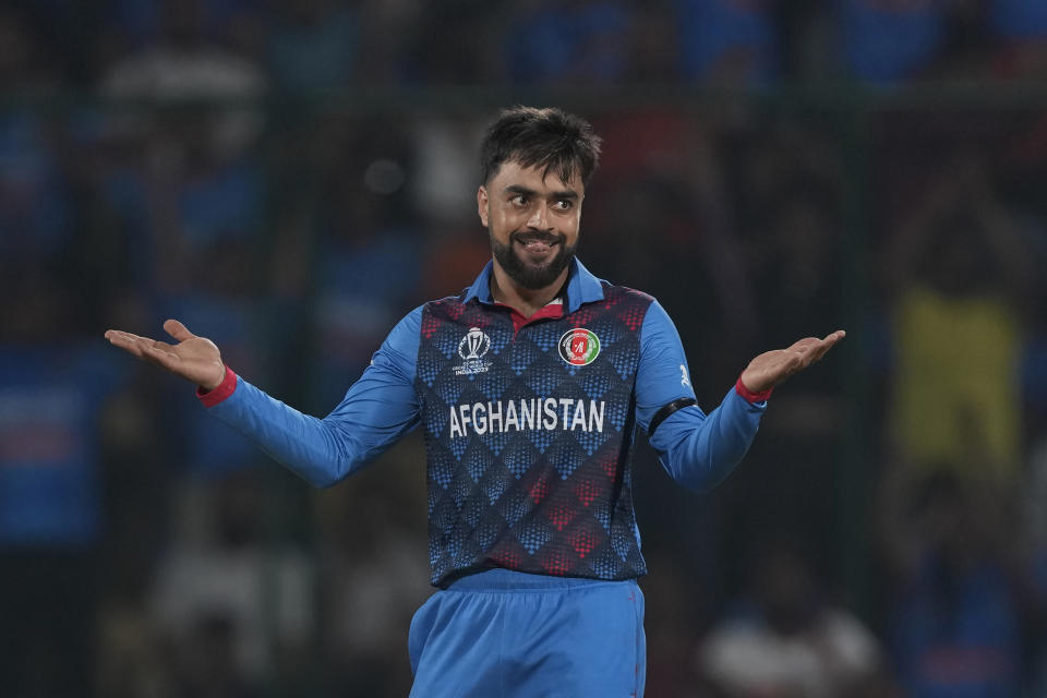 Afghanistan's Rashid Khan celebrates the wicket of India's Ishan Kishan during the ICC Men's Cricket World Cup match between Afghanistan and India in New Delhi, India, Wednesday, Oct. 11, 2023. (AP Photo/Manish Swarup)