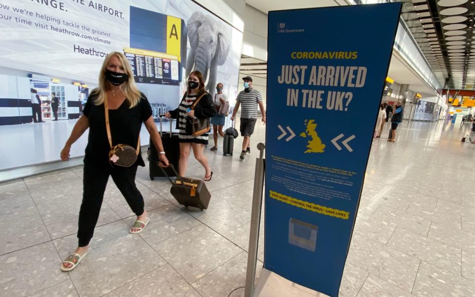 Passengers returning to Heathrow Airport from Greece in September. Strict border controls and quarantines from all countries would be needed for virus elimination - Yui Mok/PA