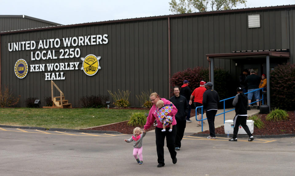 FILE - In this Thursday, Oct. 24, 2019 file photo, United Auto Worker Lindsey Higgins, exits the the UAW Local 2250 Ken Worley Hall with her two children after voting on the offer made to union workers by General Motors in Wentzville, Mo. General Motors workers voted 57.2% in favor of a new contract with the company, bringing an immediate end to a contentious a 40-day strike that paralyzed GM's U.S. factories, Friday, Oct. 25, 2019. (Laurie Skrivan/St. Louis Post-Dispatch via AP, File)