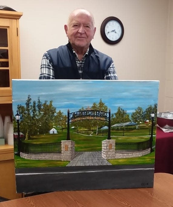 Bob Jennings with his painting of the city park gateway. Jennings created the plans and painted the design for the Salt Fork Festival 50th Anniversary Gateway.