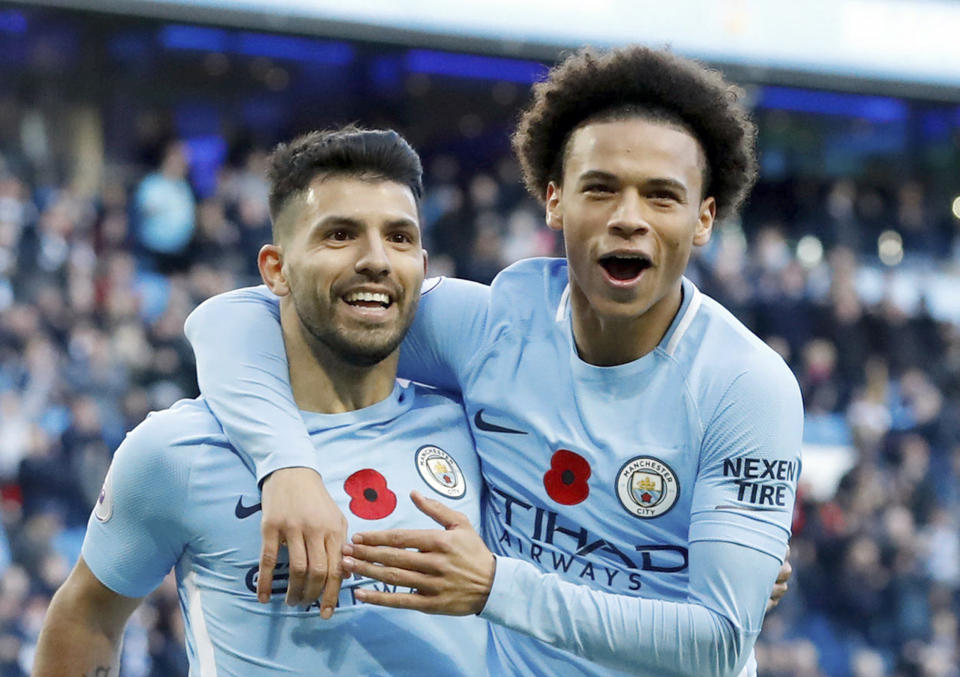 Manchester City’s Sergio Aguero, left, celebrates scoring his side’s second goal of the game with Leroy Sane