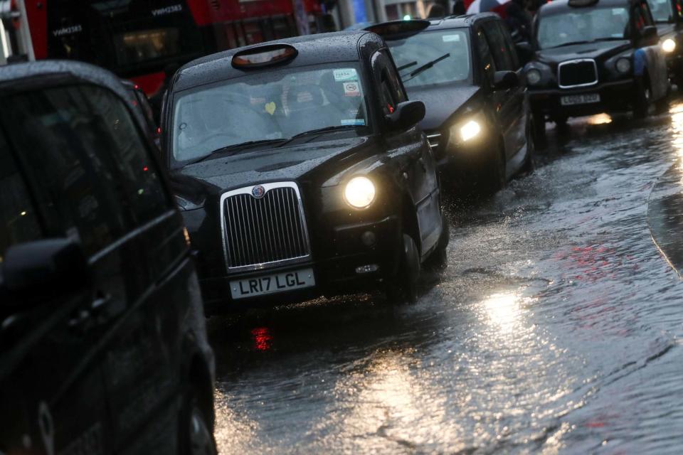 London Black taxicab's drive through a puddle on Oxford Street during Storm Dennis (REUTERS)