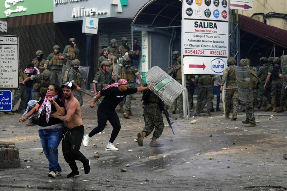 Lebanese army soldiers scuffle with protesters during a demonstration, in solidarity with the Palestinian people in Gaza, near the U.S. embassy in Aukar, a northern suburb of Beirut, Lebanon, Wednesday, Oct. 18, 2023. Hundreds of angry protesters are clashing with Lebanese security forces in the Lebanese suburb Aukar near the United States Embassy. (AP Photo/Hassan Ammar)