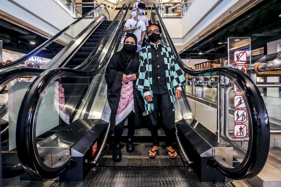 Helmi Ibrahim (right) and Siti Aishah (left) are pictured at the Mid Valley shopping centre cinema, March 5, 2021. ― Picture by Hari Anggara