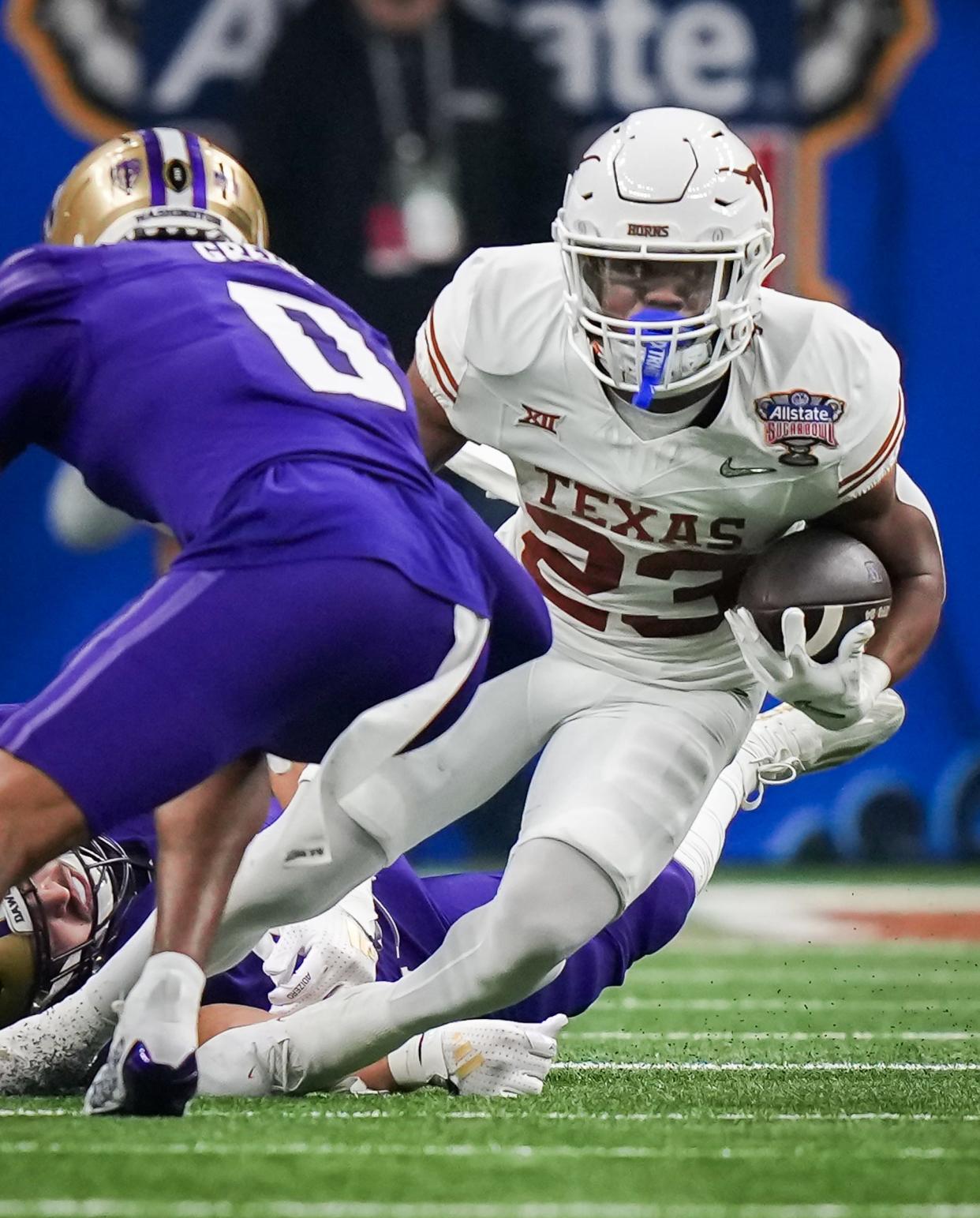 Texas running back Jaydon Blue  carries the ball against Washington in last season's College Football Playoff semifinal. What role will Blue have this season while sharing carries with CJ Baxter? Saturday's spring game will provide some clues.