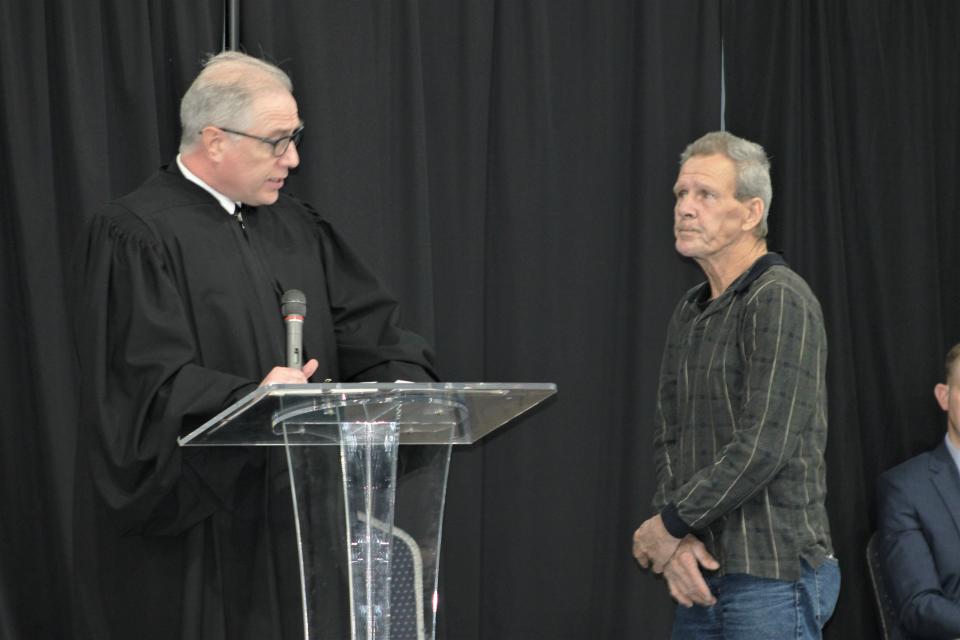 Marion County Court of Common Pleas Judge W.T. Edwards, left, talks about the accomplishments of FIRST Court graduate Michael Stacy during the drug court graduation ceremony on Friday, April 29, 2022, at First Church of the Nazarene in downtown Marion.