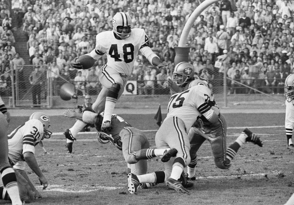 File- This Nov. 2, 1970. file photo shows Green Bay Packer cornerback Ken Ellis (48) leaping as he returns a 49er punt in third quarter NFL action in San Francisco. Packer guard at right is Forrest Gregg (75). "It's going to be a long time, another 100 years, before somebody wins himself six titles," said Herb Adderley, the Hall of Fame cornerback for Vince Lombardi’s great Green Bay Packers teams of the 1960s. Adderley, who turns 80 next month, won five championships in Green Bay, including the first two Super Bowls, plus another with Tom Landry’s Dallas Cowboys in 1971, as did Forrest Gregg, who died last month at age 85. (AP Photo/File)