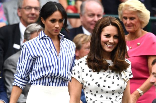 <p>For a day at Wimbledon with her new sister-in-law Kate Middleton, Meghan wore a Ralph Lauren pinstripe shirt in a boxy style that was perfectly balanced by her smokey eyes and loose updo.</p>