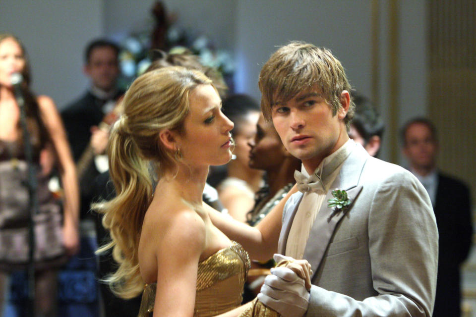 Blake Lively in a glamorous strapless gown dances with Chace Crawford in a formal suit at a ballroom event in a scene from "Gossip Girl."