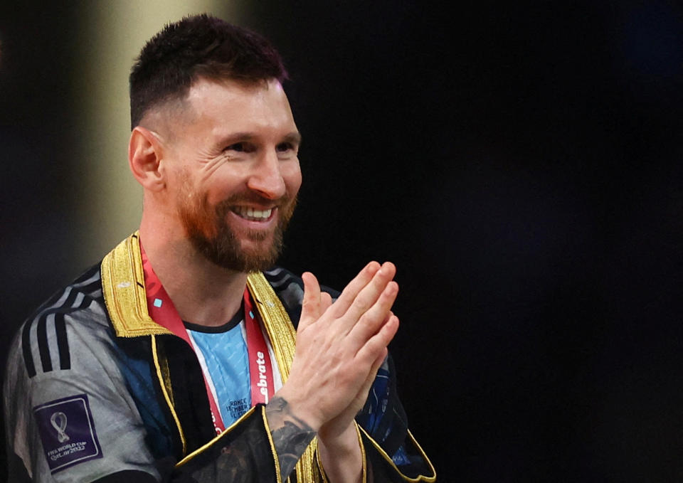 On December 18, 2022, Argentina's Lionel Messi celebrates during the trophy presentation after winning the World Cup. REUTERS/Kai Pfaffenbach