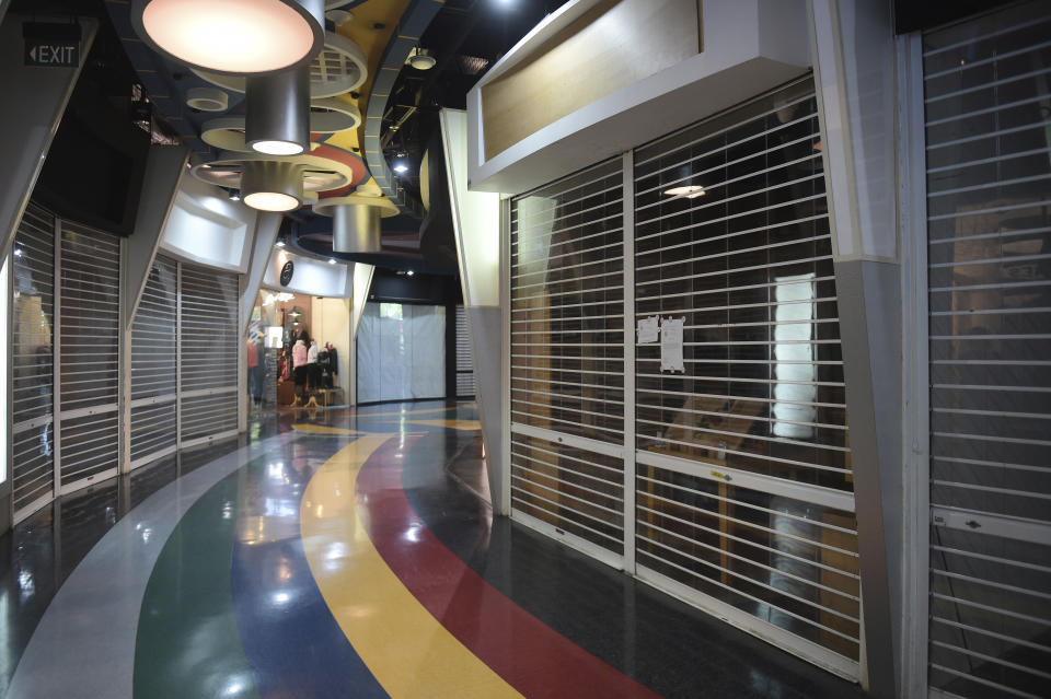 Shuttered stores where tenants have moved out are seen in a mall along Singapore’s shopping street, Orchard Road on Thursday, July 27, 2017. (AP Photo/Joseph Nair)